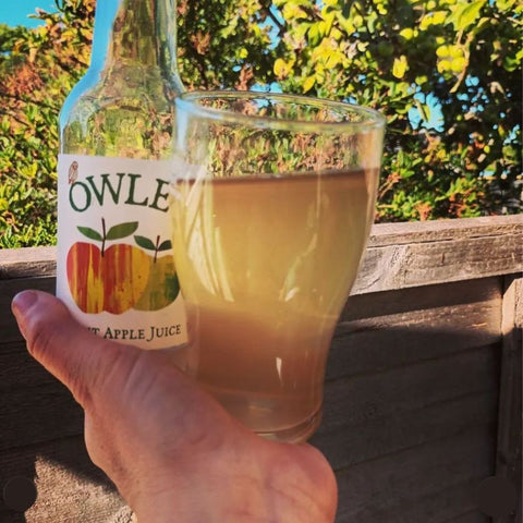 bottle of cox apple juice in a glass