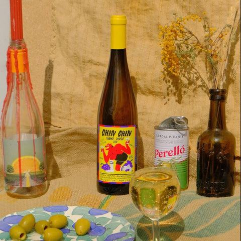 chin chin vinho verde noble rot in a glass next to olives