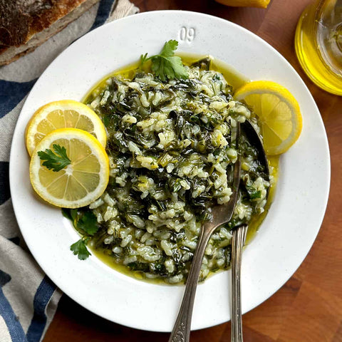 spinach and rice dish with olive oil and lemons