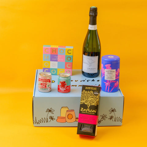 Celewbration food and wine products on a hamper box with a yellow background