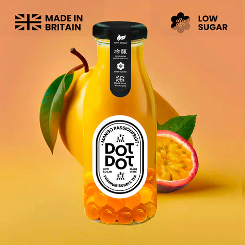 Bottle of Dot Dot mango passionfruit juice with a yellow background, featuring the brand logo and 'Made in Britain' text.