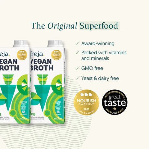 Two cartons of Rejea Vegan Broth displayed on a light cream background with marketing text and award badges. The packaging features green and white graphics with the words 'VEGAN BROTH' and 'Gluten Free Yeast Free Dairy Free'.