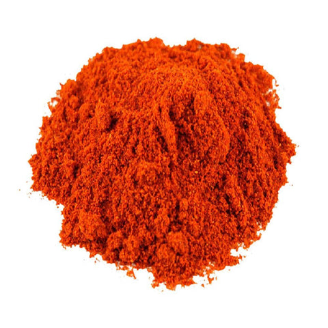 A mound of cayenne pepper on a plain white background.