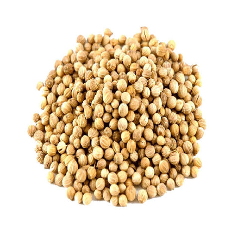 Pile of coriander seeds on a white background
