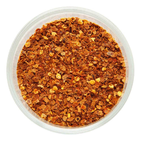 organic chilli flakes on white background