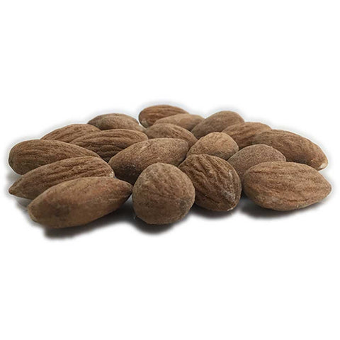 close up of salted almonds on a white surface