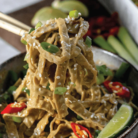 chopsticks holding fettuccine noodles