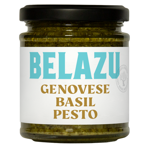 A glass jar of Belazu Genovese Basil Pesto with a black lid and a white label featuring light blue and gold text, set against a plain white background.