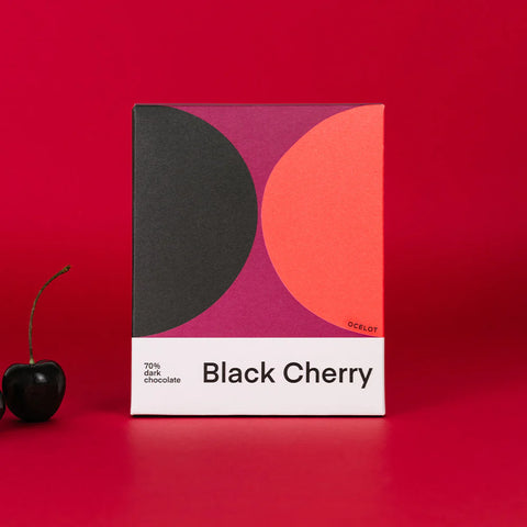 black cherry 70% dark chocolate on red background with a cherry