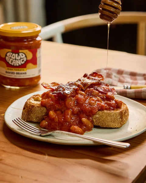 Baked beans on toast with a jar of Gold Beanz in the background