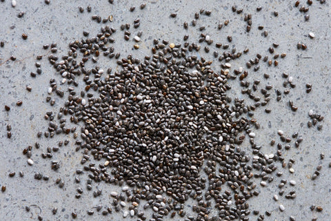 Close-up of chia seeds on a gray surface