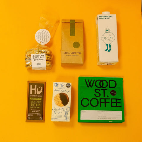 Collection of coffee and chocolate products on a bright orange background