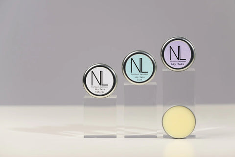 tins of lip balm on grey background