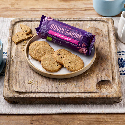 package of biscuits on a plate with open biscuits on a wooden cutting board