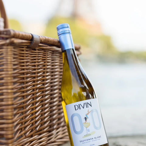Bottle of Divin Sauvignon Blanc wine with a wicker basket in the background