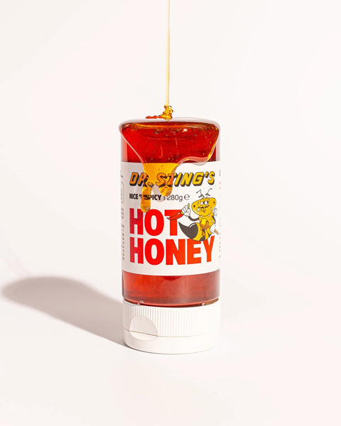 squeezy bottle of hot honey with drizzle pouring down the bottle