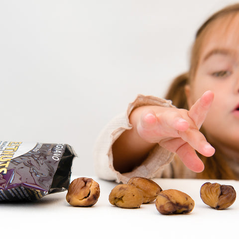 hand reaching for chestnuts on table 