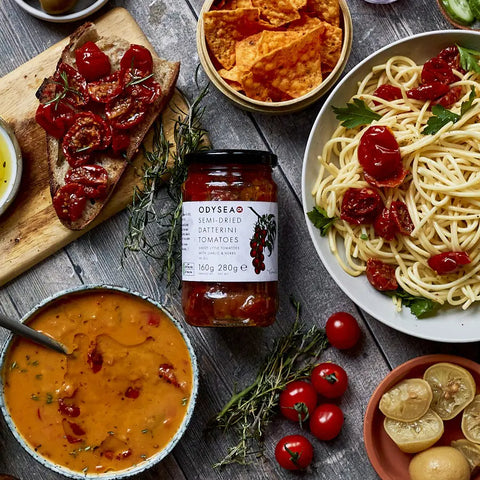 jar of tomatoes next to soup, pasta, and bread