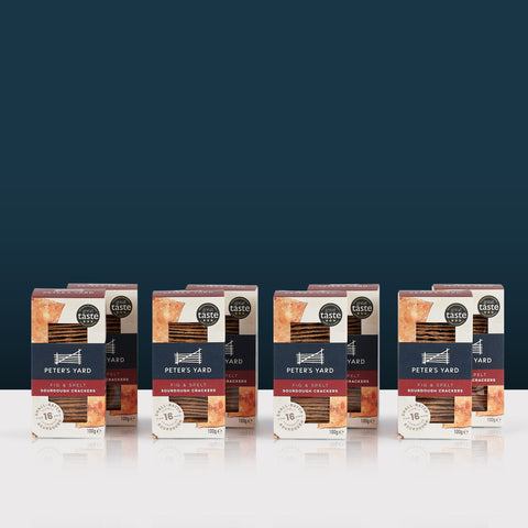 boxes of peter's yard crackers on white surface in front of blue background
