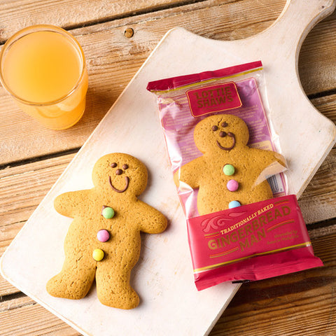 gingerbread man on cutting board on wooden surface 