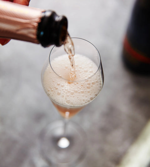 pouring rose into glass