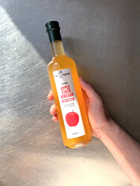 hand holding Mr Organic Apple Cider Vinegar