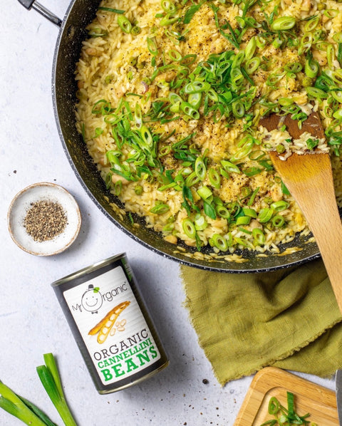 can of mr organic cannellini beans next to an orzo dish
