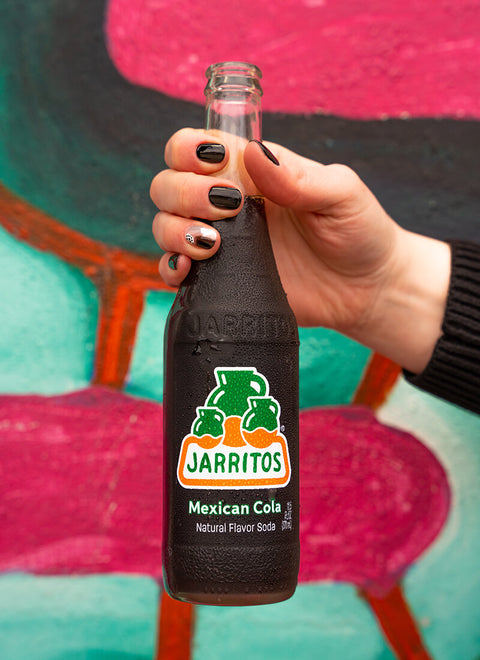 hand holding bottle of mexican cola jarritos