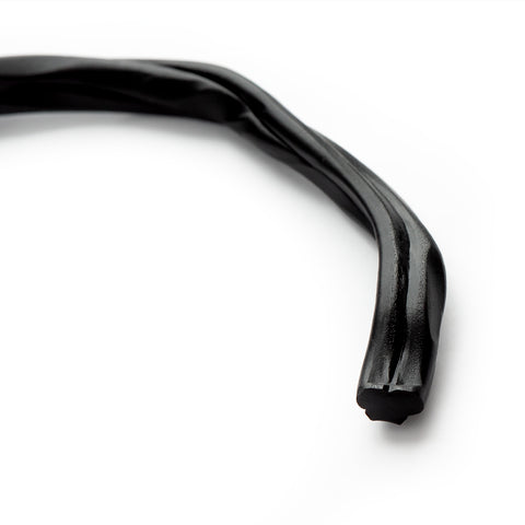 A close-up of liquorice on a plain white background.