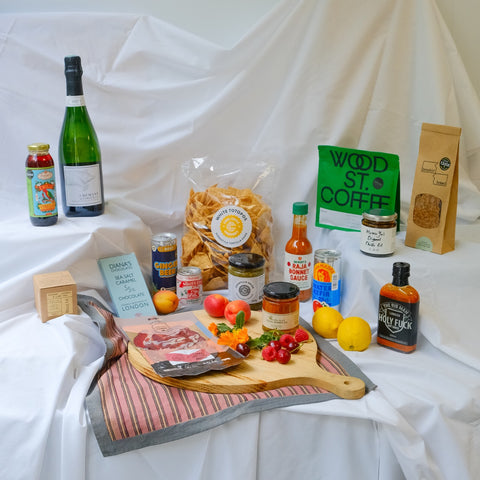 Assorted food items and drinks on a table with a white cloth background