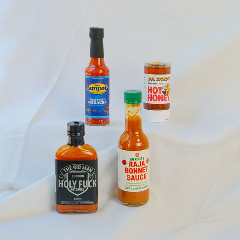Collection of london hot sauce bottles on a white background