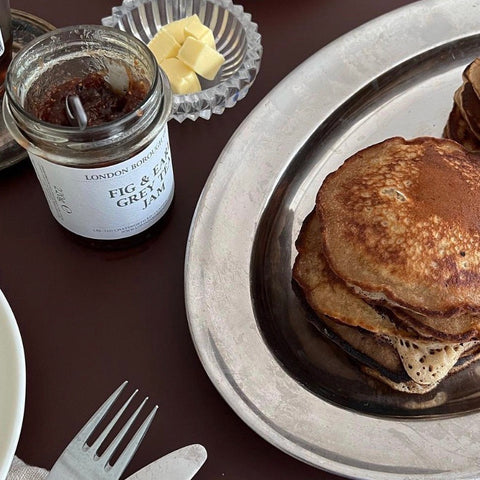 Pancakes with an open jar of fig jam