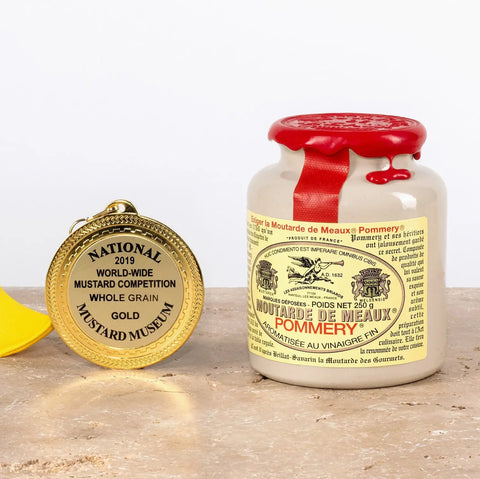 Jar of Pommery mustard with a gold medal on a wooden surface
