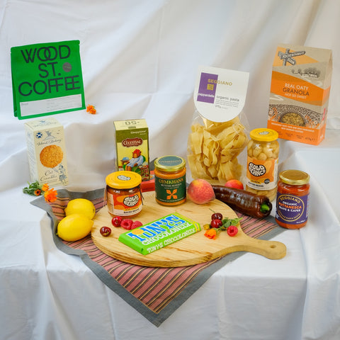 Assorted groceries including pasta, lemons, and a variety of products on a white background with 'Wood St Coffee' sign.