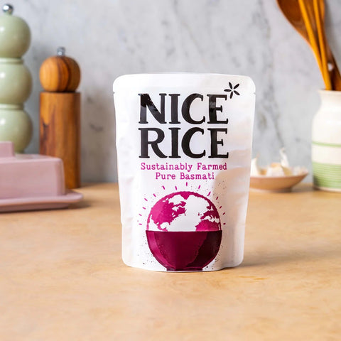 pouch of rice in purple and white bag with 'sustainably farmed basmati' written on it