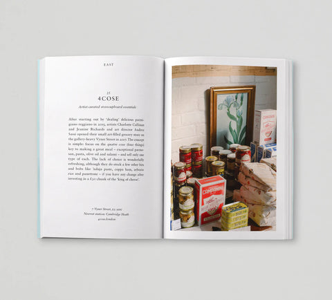 Open book showing text on one page and a photograph of a room with various items on the other.