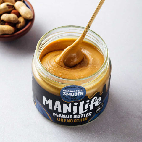 container of peanut butter open with spoon in it