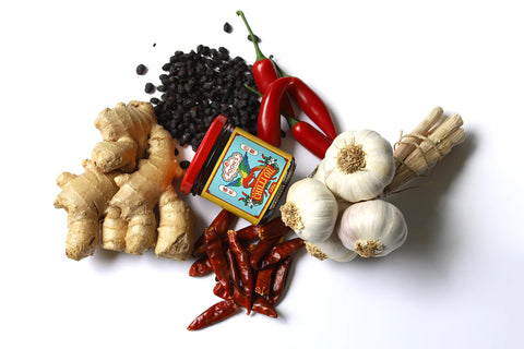 jar of chilli oil with ingredients on white surface
