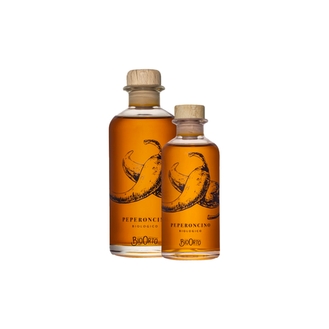 two bottles of organic chilli oil on a white background