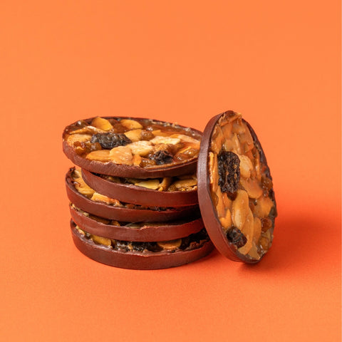 Stack of Percy's Florentine biscuits with orange background