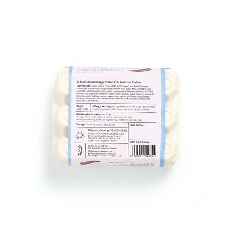 A wrapped bar of chocolate egg-shaped soap with a white paper label showing product details, photographed on a clean white background.