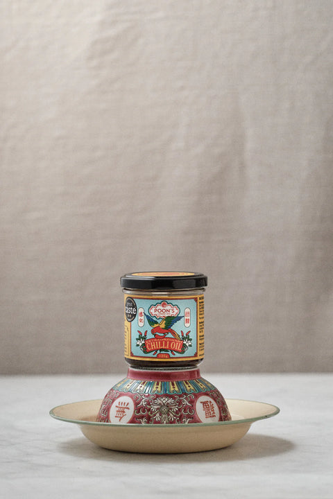 jar of chilli oil on stand on white surface