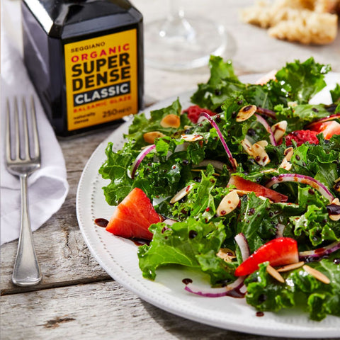 Bottle of Seggiano Organic Super Dense Balsamic Glaze 250 ml next to a salad with the balsamic on it