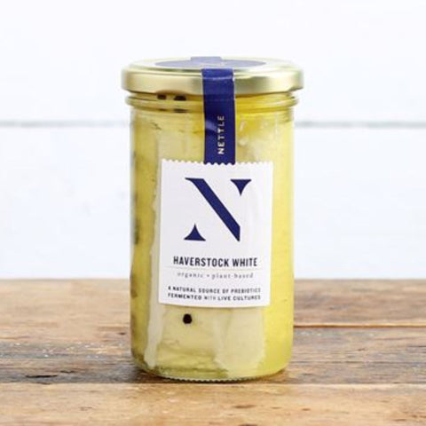 Jar of Haverstock White on a wooden surface with a white background