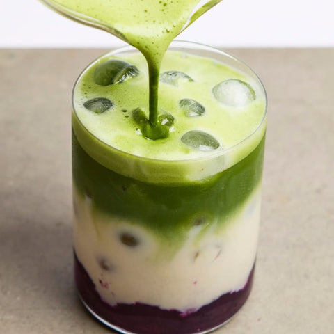 clearspring organic matcha green tea powder 40g in a cup  poured over milk