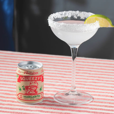 A can of Whitebox Squeezy's Margarita cocktail in a margarita glass