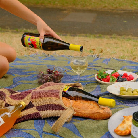 chin chin vinho verde noble rot bottle being poured in a glass at a picnic 