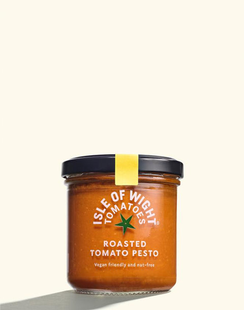 jar of roasted tomato pesto on white background