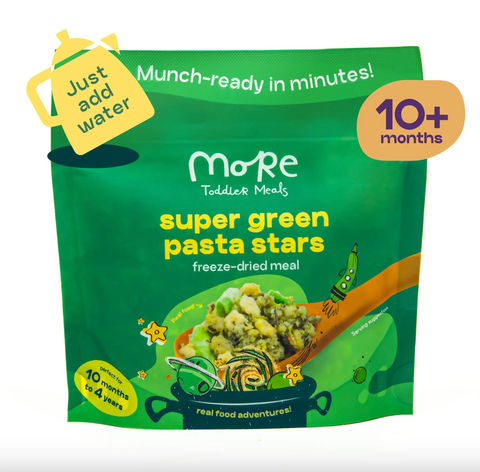Green package of 'super green pasta stars' freeze-dried meal for toddlers with branding and text on a white background.