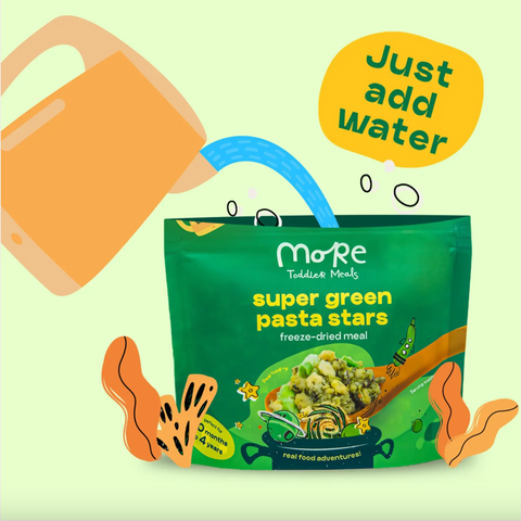 Green package of 'super green pasta stars' with a water being poured into it, on a light green background.